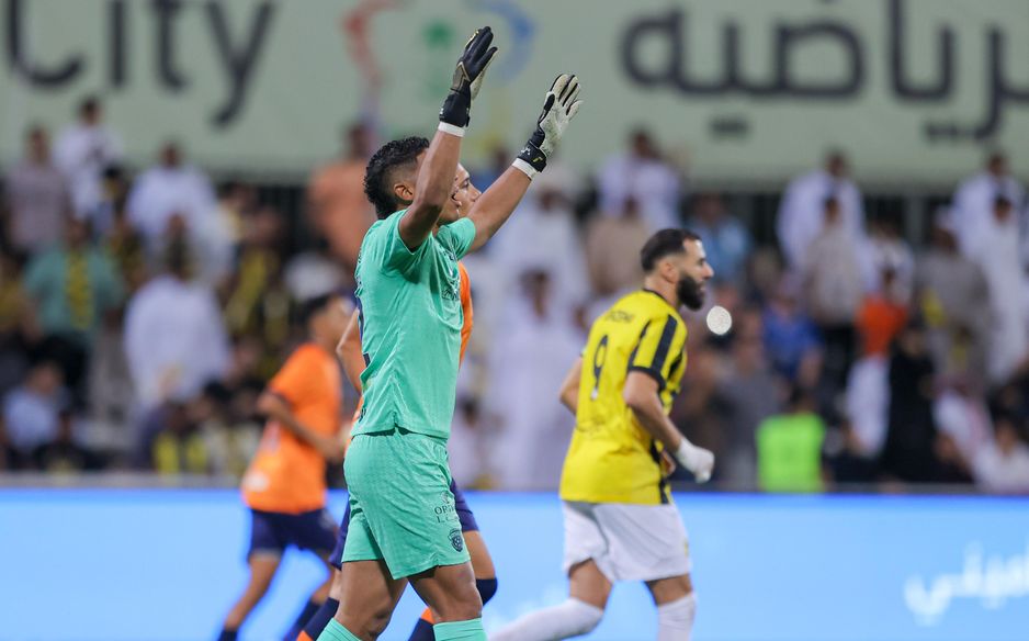 Al Fayha's Orlando Mosquera celebrates his late penalty save from Al Ittihad's Karim Benzema