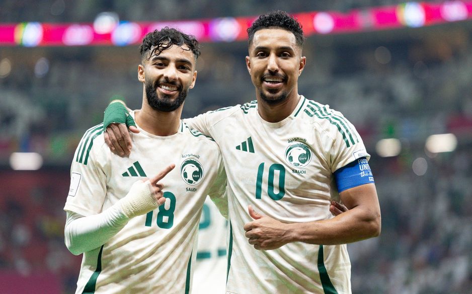 Saleh Abu Al Shamat (L) and Salem Al Dawsari celebrate Saudi Arabia's win v Comoros at the 2025 FIFA Arab Cup